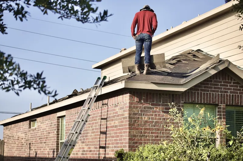 Professional roofer working on a residential roof in Ridgely